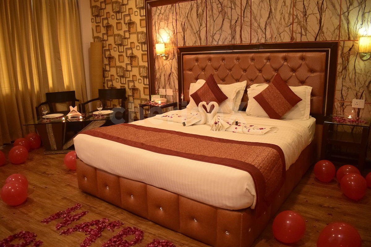 Room Decorated with Rose Petals and Balloons