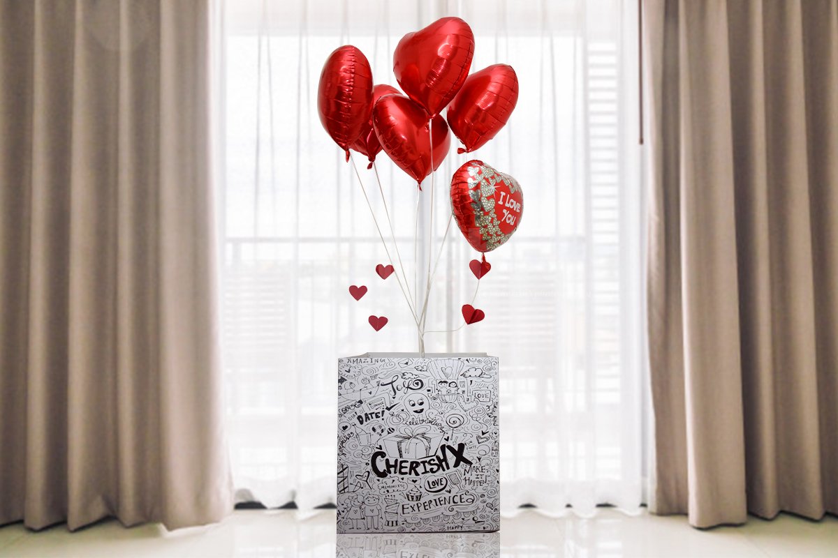 Valentine's day love surprise box featuring heart shaped foil balloons