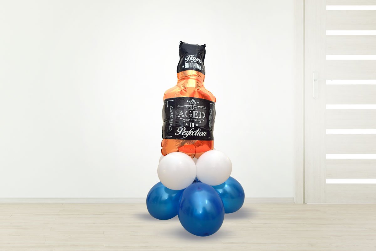 A Whiskey Bottle Foil Balloon on a bunch of balloons to add to the decor.