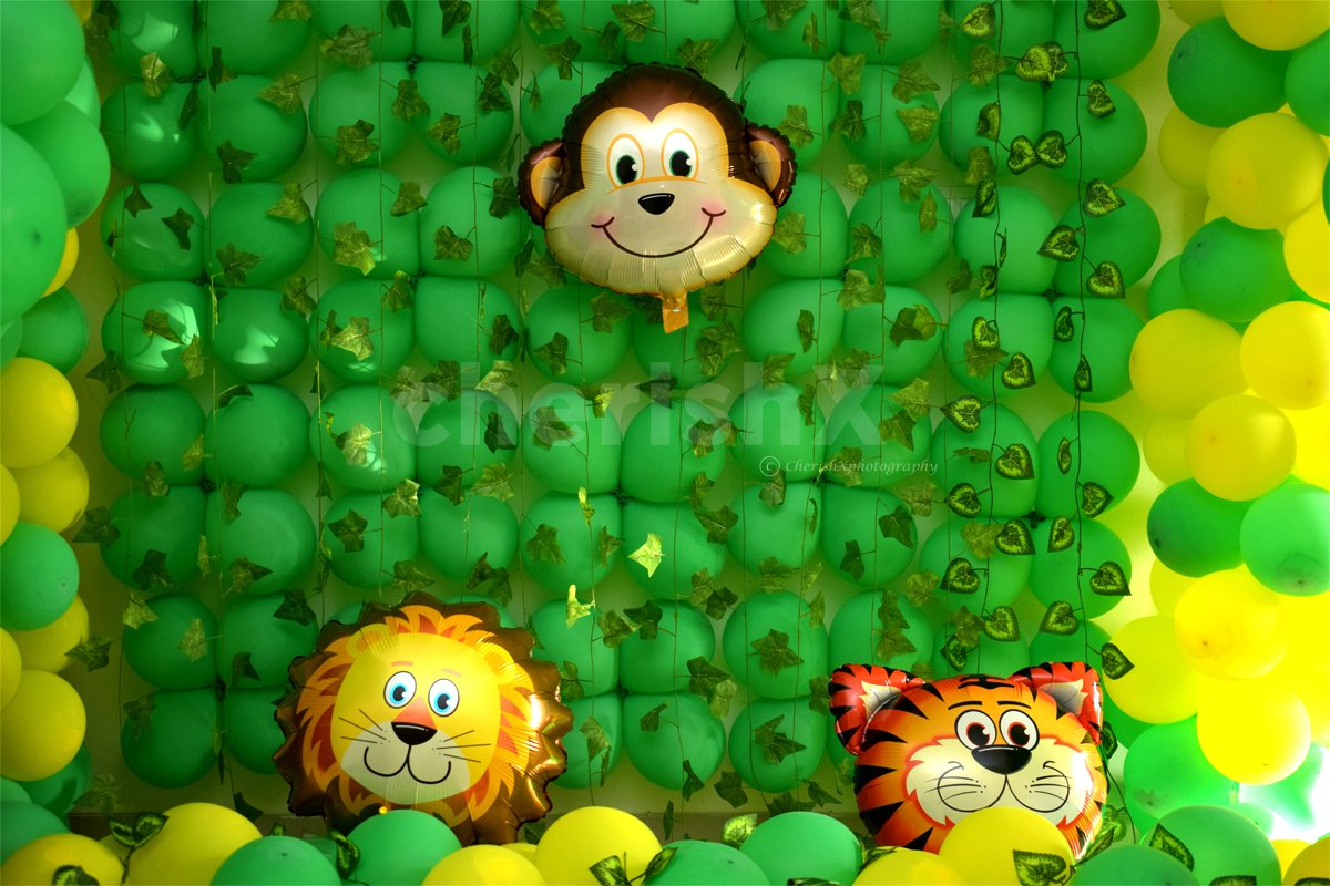 The wall is covered with green balloons for giving the look of the Lion King Movie.