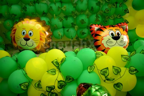 Tiger and Lion Foil Balloons surrounded by green and yellow balloons to give the look of a Jungle.