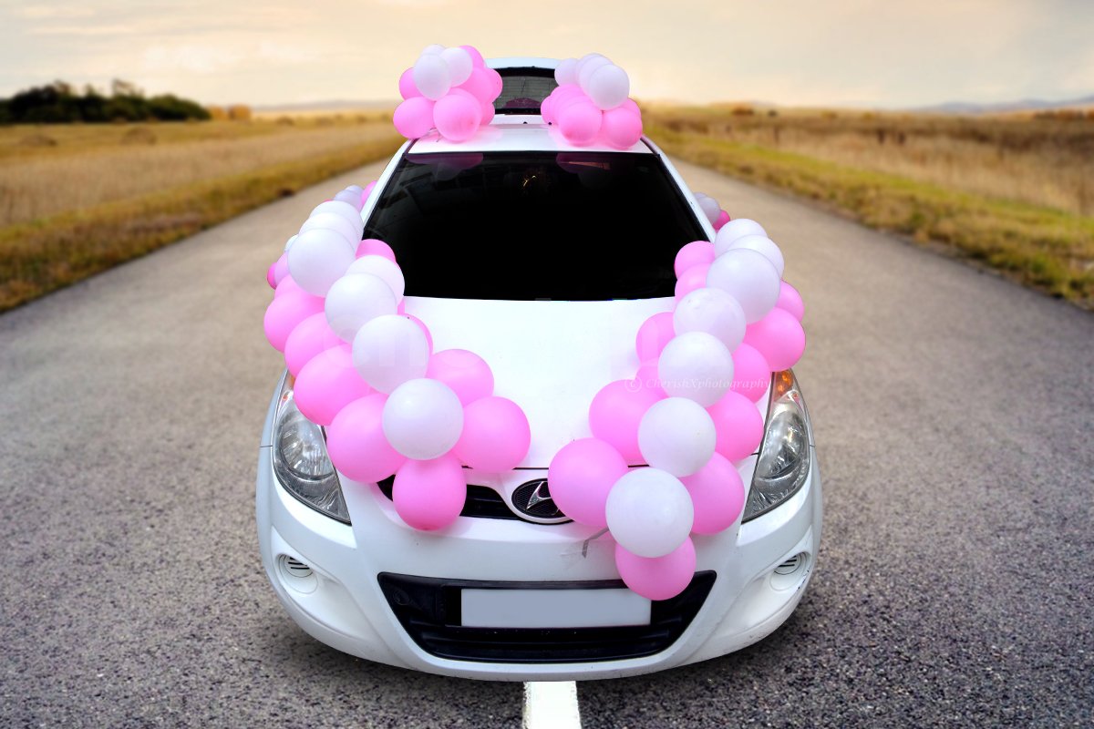 Make it special for the mother-to-be with this pink and white coloured car boot decor.