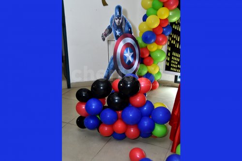 A Captain America Cut-out on a balloon bunch stand.