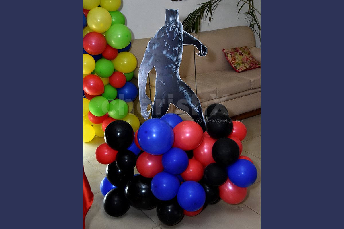 A Black Panther Cut-out stand on a colourful balloon bunch.