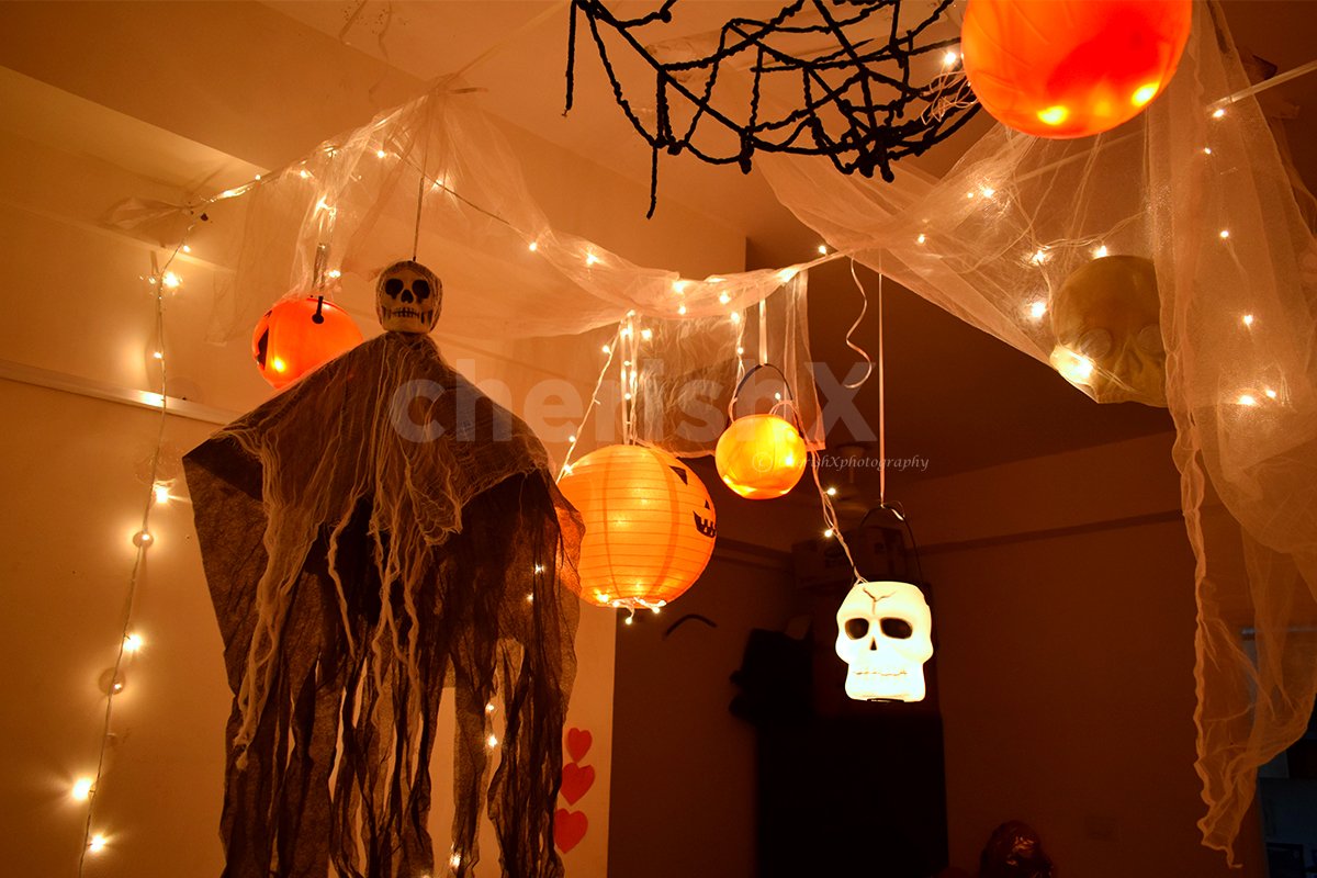 Halloween themed decoration with spooky lanterns, spider webs, and skeleton shapes