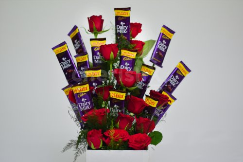The chocolate and roses are arranged as a flower bouquet.