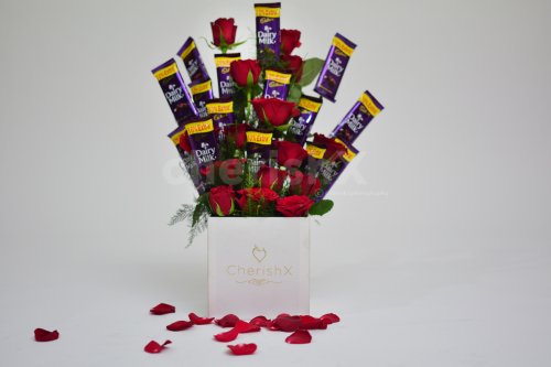 There are 15 roses and chocolates in this adorable bucket.