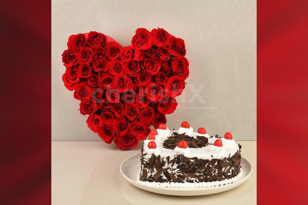 50 Red roses heart arrangement and a heart shape black forest cake home delivery