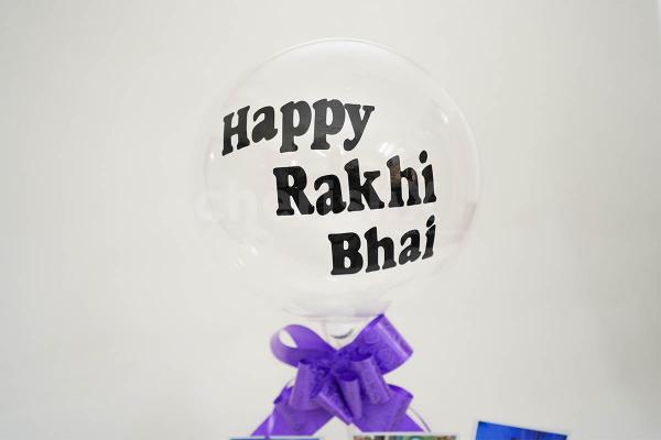 The bucket has a "Happy Rakhi" printed bubble balloon.