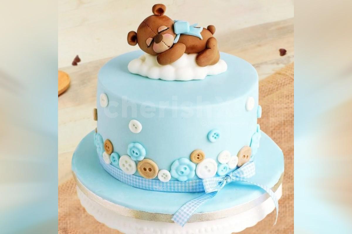 close up Amazing cake for boy's first Birthday. Blue and white colors with  Bear cub from sugar mastic Stock Photo - Alamy