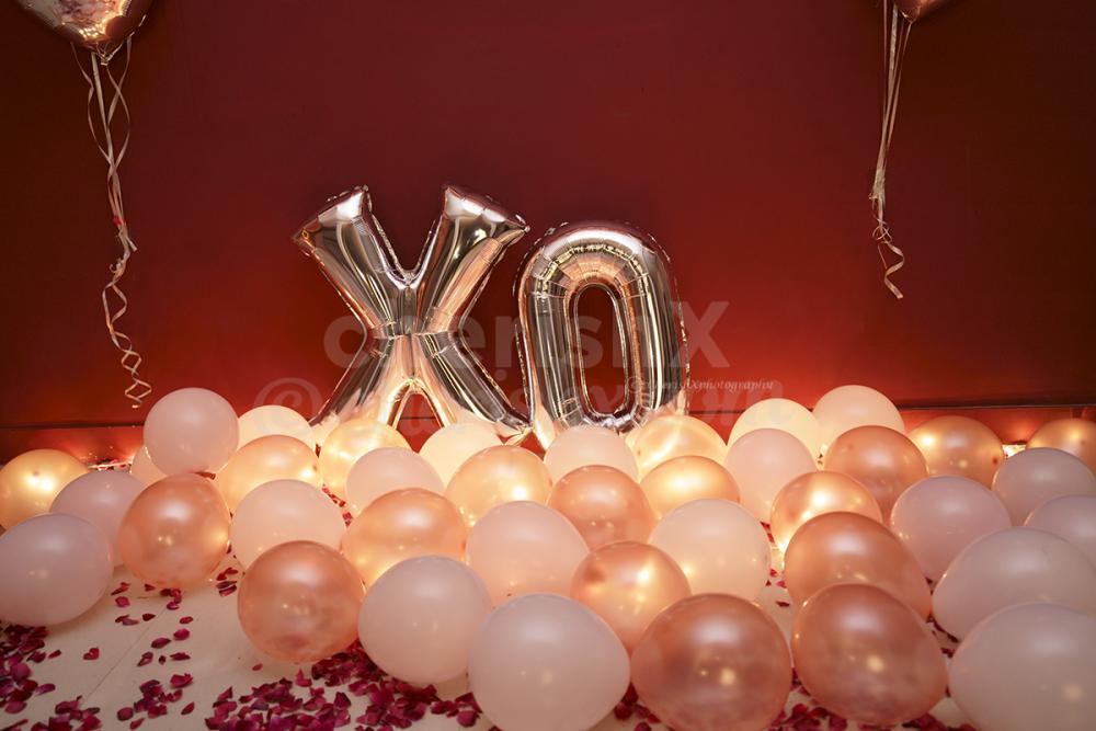 Rose Gold Love XO Room Decoration with 100 Rose Gold and Pink Pastel Balloons and a XO Silver Letter Foil Balloon.