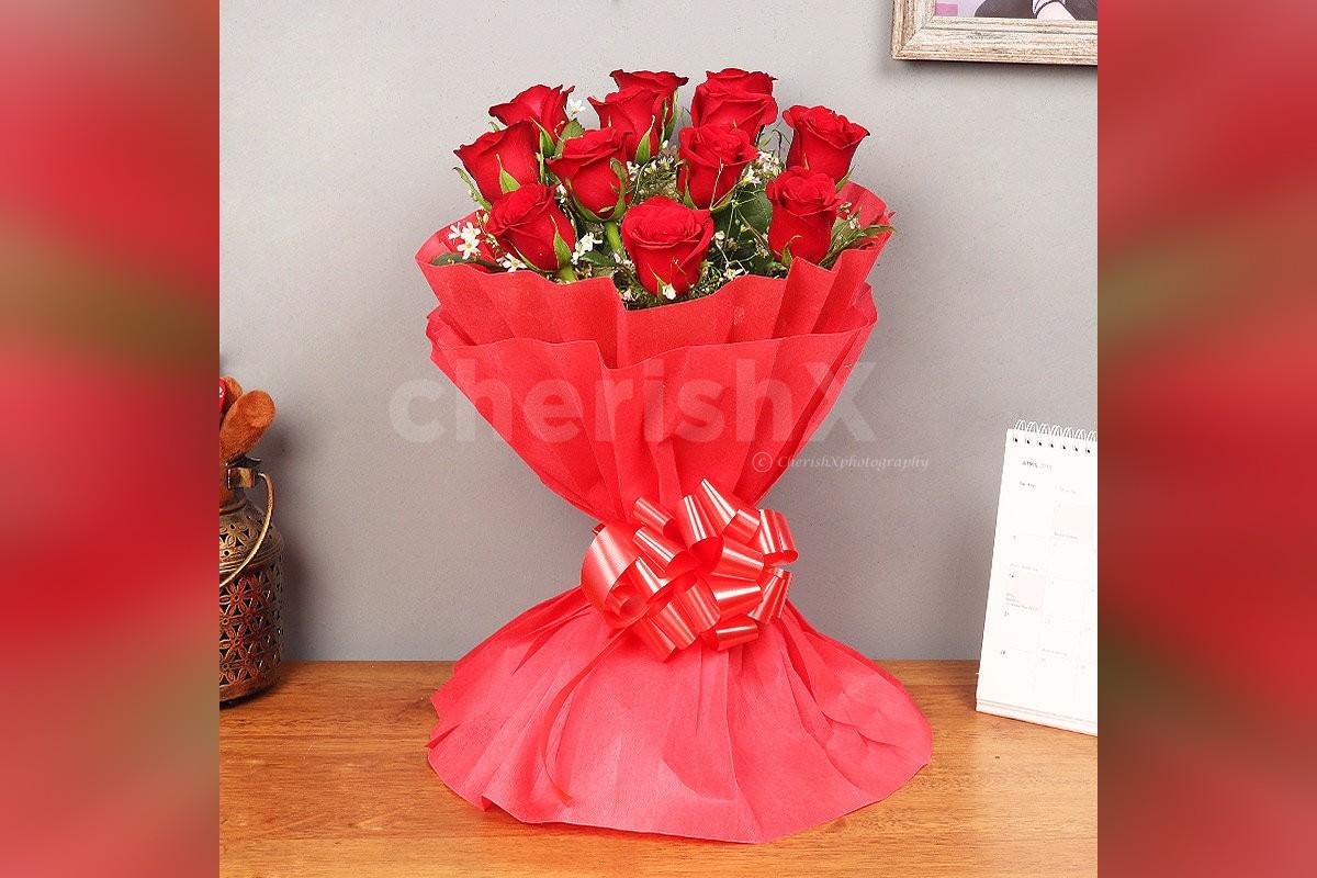 Send a simple 12 Red Roses in red color paper Bouquet to surprise them