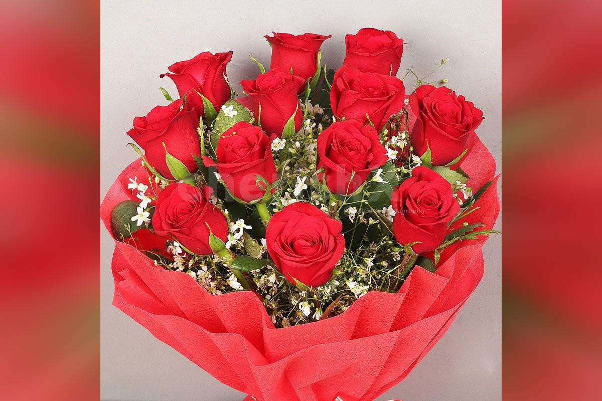 Send a simple 12 Red Roses in red color paper Bouquet to surprise them Free & OnTime Delivery