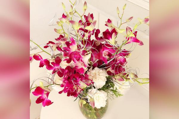 6 Purple Orchids and 10 White Carnations in a glass vase Bouquet