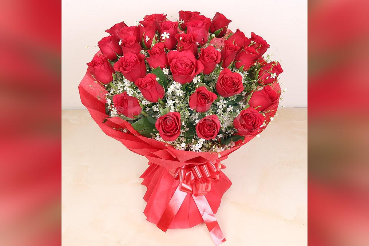 Send a simple 30 Red Roses in red color paper Bouquet to surprise them
