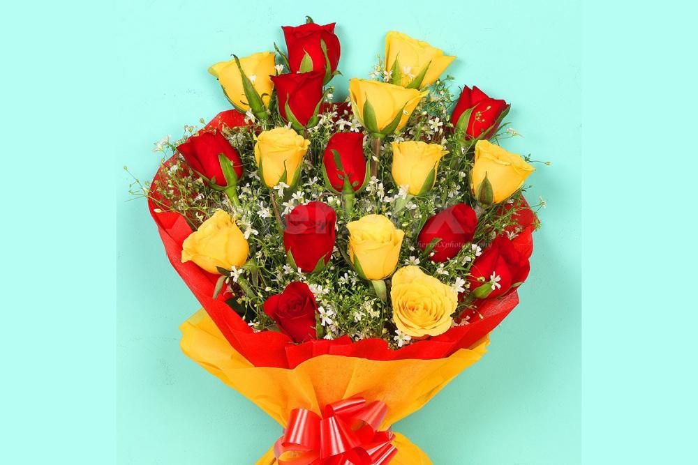 Send a simple Bunch of 18 red and yellow roses in red and yellow color paper Bouquet to surprise