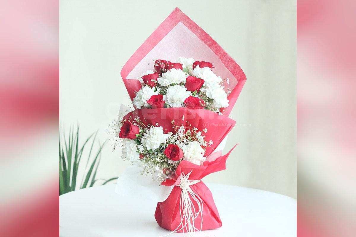 Send a simple bunch of 10 white carnation and 10 red roses in Red & White Paper Bouquet to