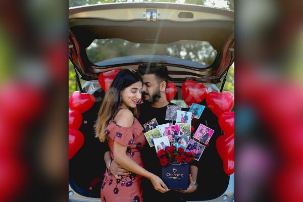 A loving couple with CherishX's Rose Bucket with photos.