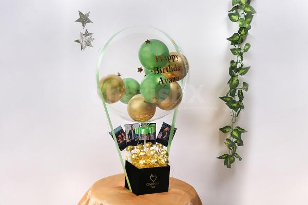 Send wishes with this extraordinary Gold & Green Balloon Bucket with Chocolates!