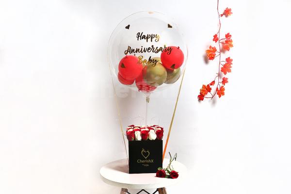 A heart-warming balloon bucket filled with white and red roses!