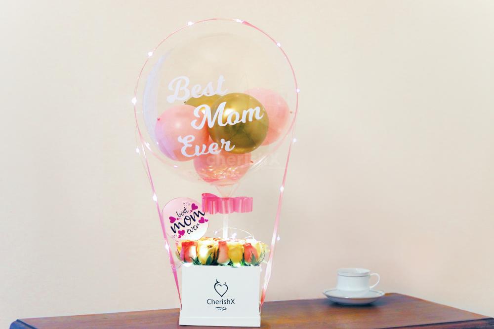 Gift this Mother's Day loving bucket filled with balloons and flowers to make the day special for your mother!
