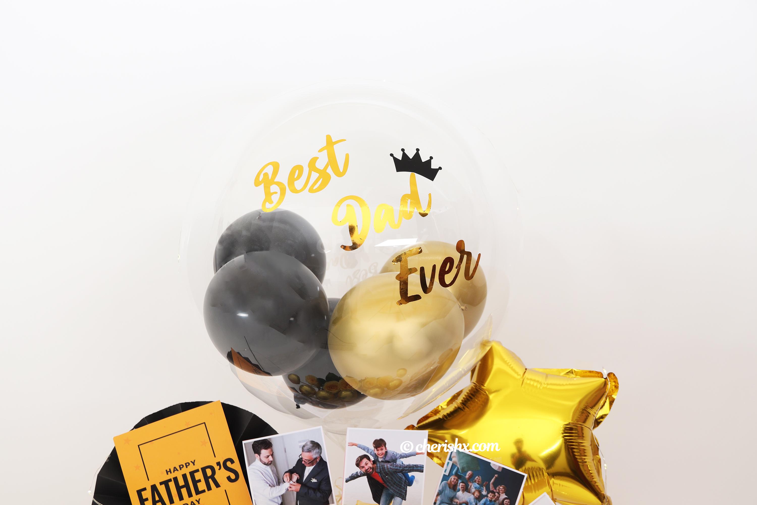 CherishX’s Black & Gold Father’s Day Bucket consists of a Bubble Balloon Filled with black and gold chrome balloons!