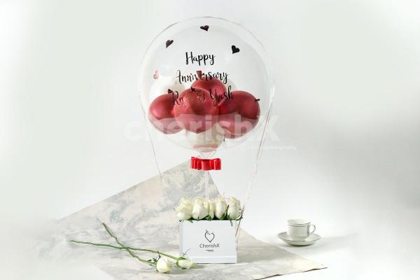 Rosegold Balloon bucket with white roses delivery in Bangalore