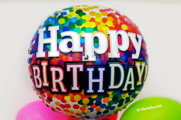 A Vibrant Happy Birthday Foil Balloon.