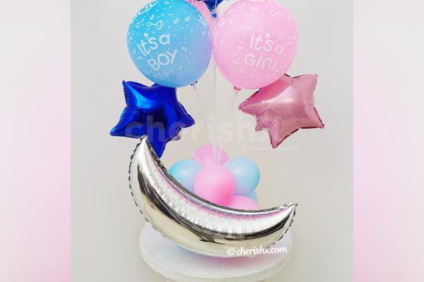 Baby shower balloon bouquet with blue and pink balloons.
