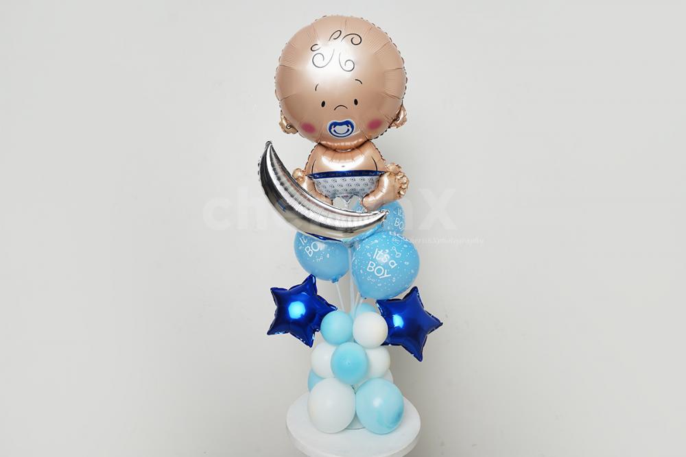 A baby boy face foil balloon.