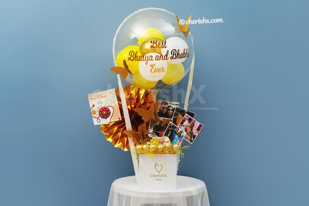 A Bubble balloon filled with yellow, pastel yellow, white latex and golden chrome balloons with a Golden Butterfly on it.