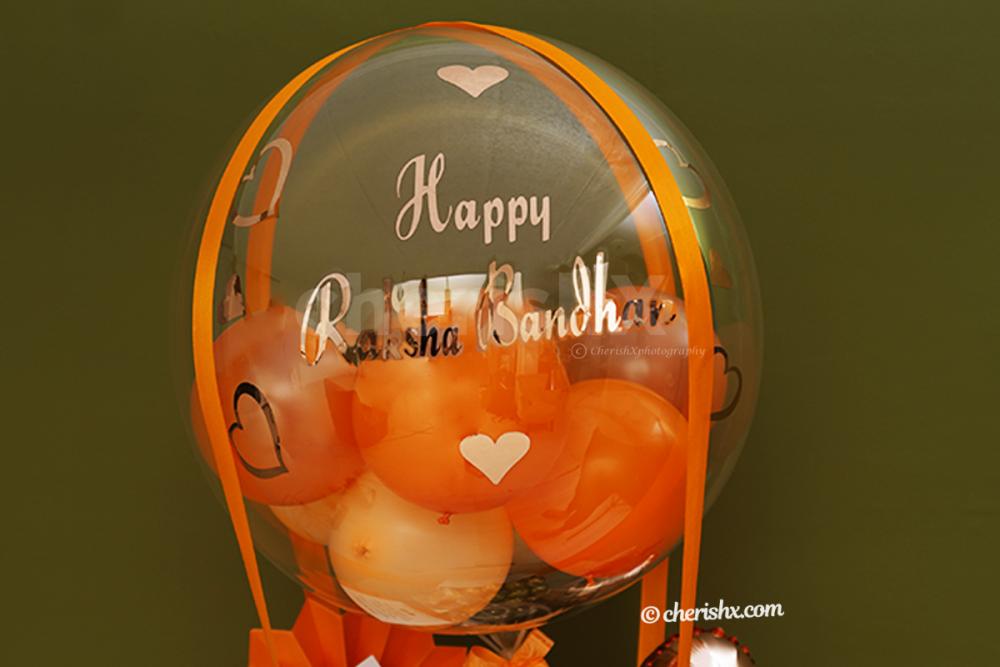 Surprise your close ones with Orange & Peach Rakhi Balloon Bouquet filled with chocolates.