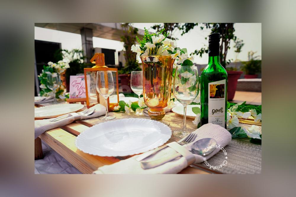 Small Easel Stand with A5 size Creative placed on the table with a golden lamp and a bottle of wine.