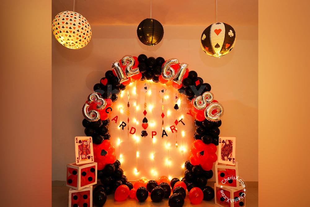 A beautifully curated Decor made with an arch of black and red latex balloons for your card party.