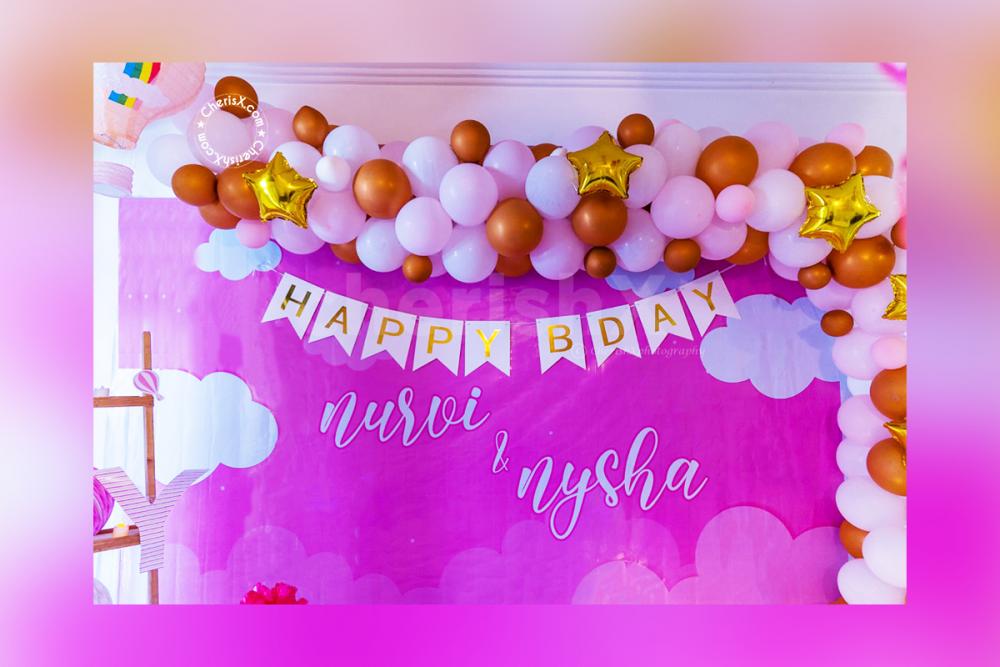 Wall Decoration with Balloon Arch and a personalised backdrop.