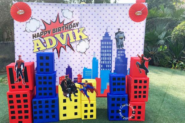 Bulding Structure with superhero cutouts and a personalised backdrop available in Superhero Themed Birthday Decor!