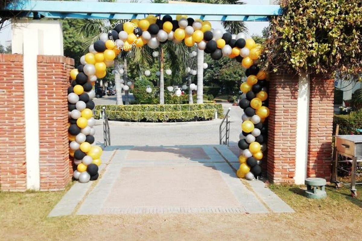 CherishX's Black and Golden Decor includes entrance arch of silver, golden chrome and black balloons.