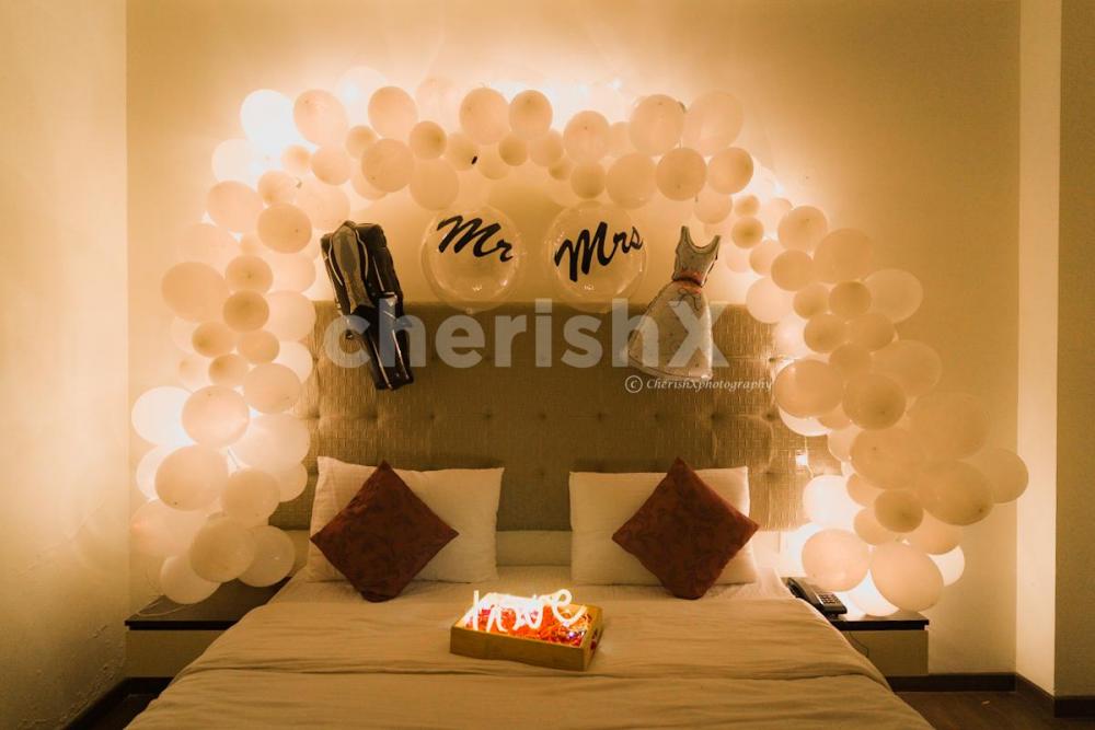 Celebrate your first night by surprising your partner with beautiful white theme decor offered by CherishX!!