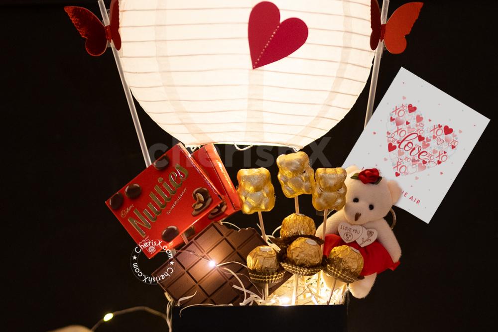 Surprise your partner this Valentine's Day with CherishX's Exclusive Chocolate Parachute Bucket Gift!
