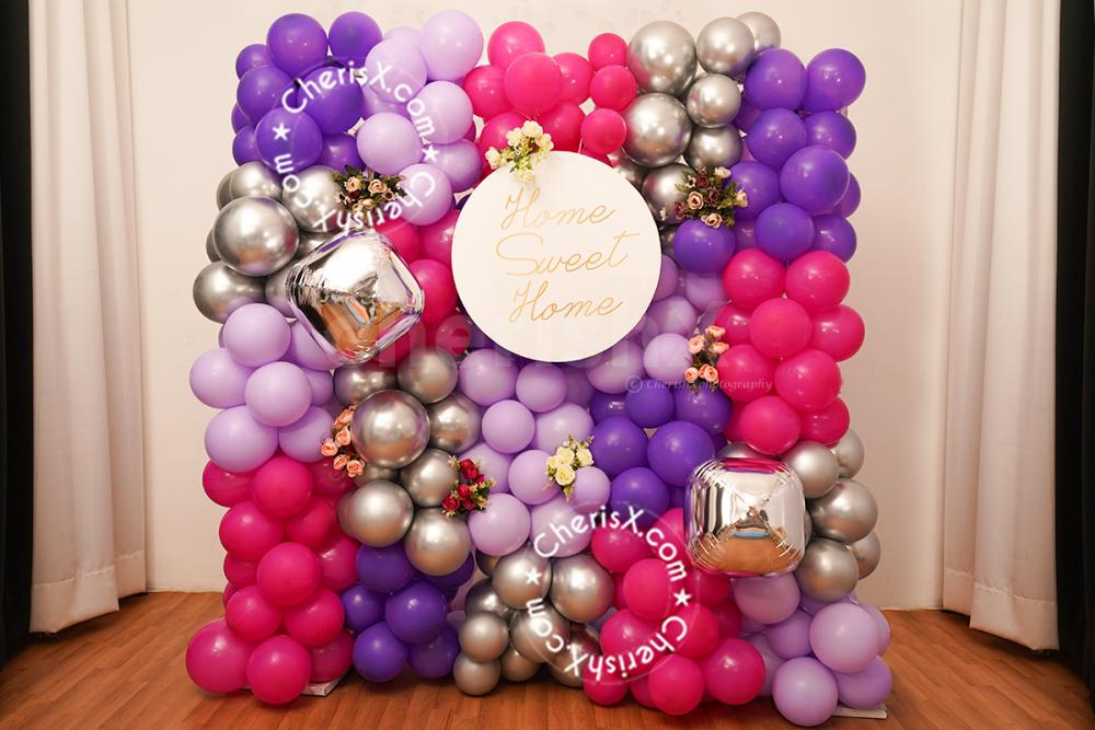 Have an unforgettable housewarming with these special purple and silver balloon decorations.