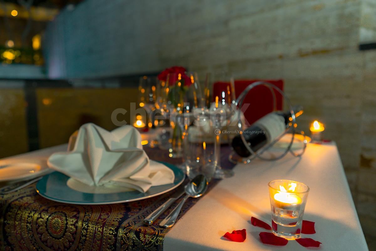 An intimate dining experience with candles, balloons, and more