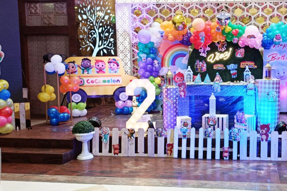 Design the stage with paper cutouts, balloon pillars, and photobooth