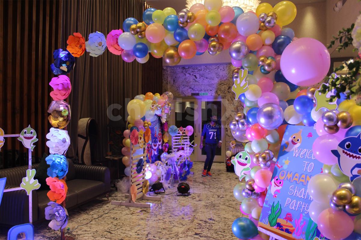 Personalize your birthday celebration with a cake table and balloons decorated as per your kid's choice