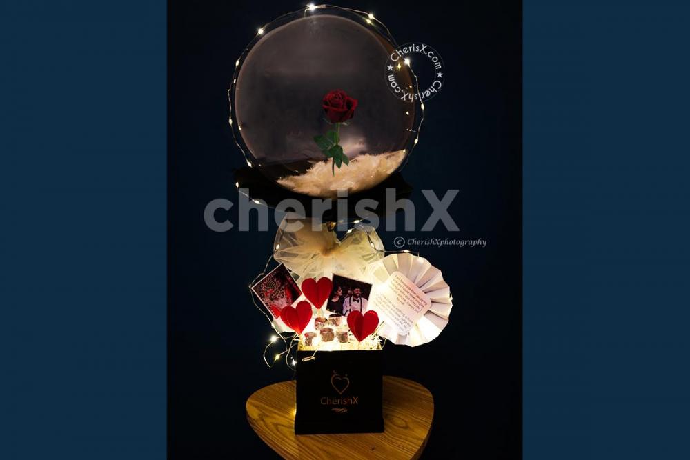 CherishX's Red Rose Bucket is filled with Chocolates, Photos and a message card.