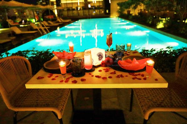 The candles and rose petals added to your poolside table adds love to the air