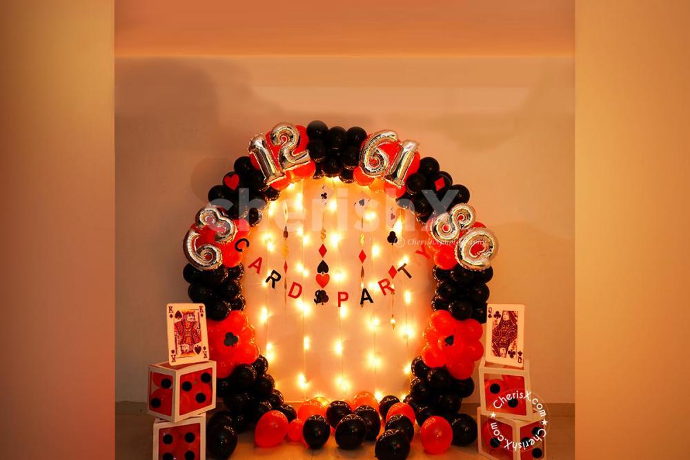A beautifully curated Decor made with an arch of black and red latex balloons for your card party.