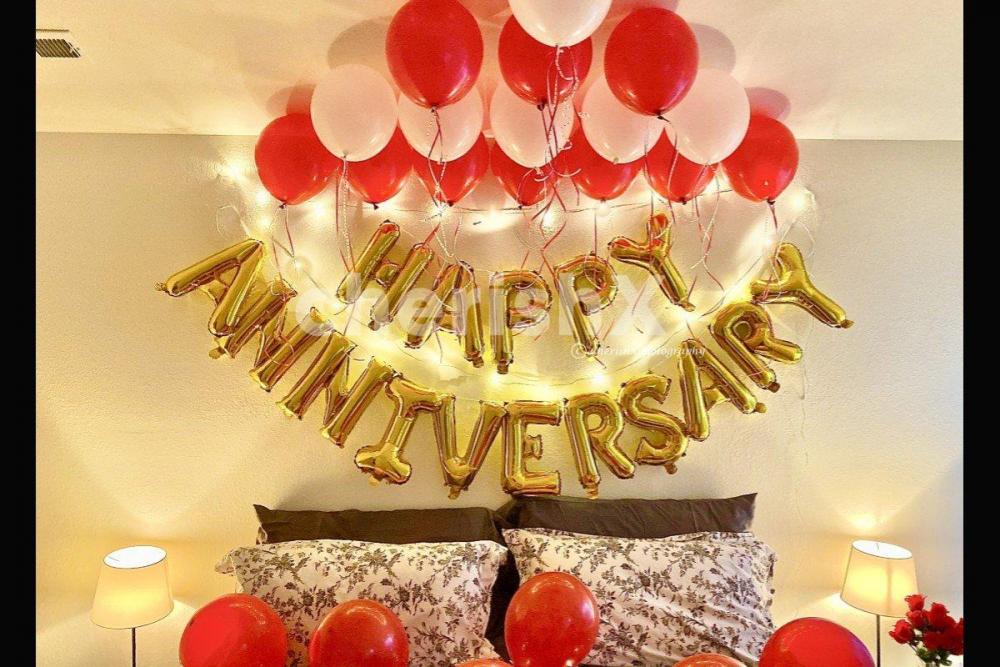 Red and Black Balloon Theme used for Anniversary Special Balloon Room Decoration.