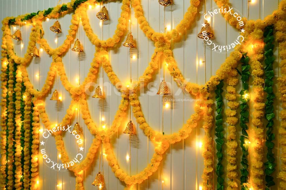 A mix of yellow and green garland around the wall will set the perfect pooja atmosphere