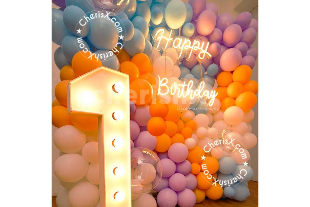Decorate your entire wall with balloons and add a cake and teddy to make it a complete party kit