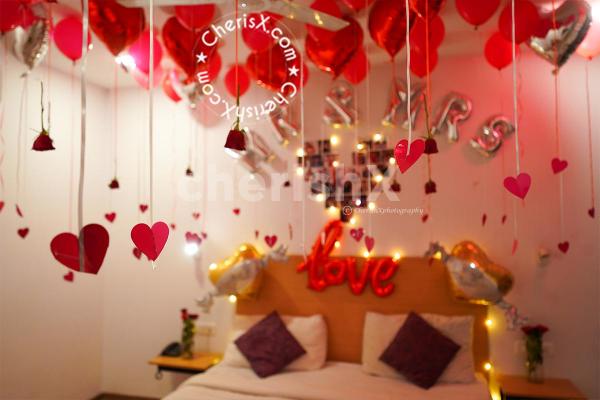 The red roses and balloons make the night romantic
